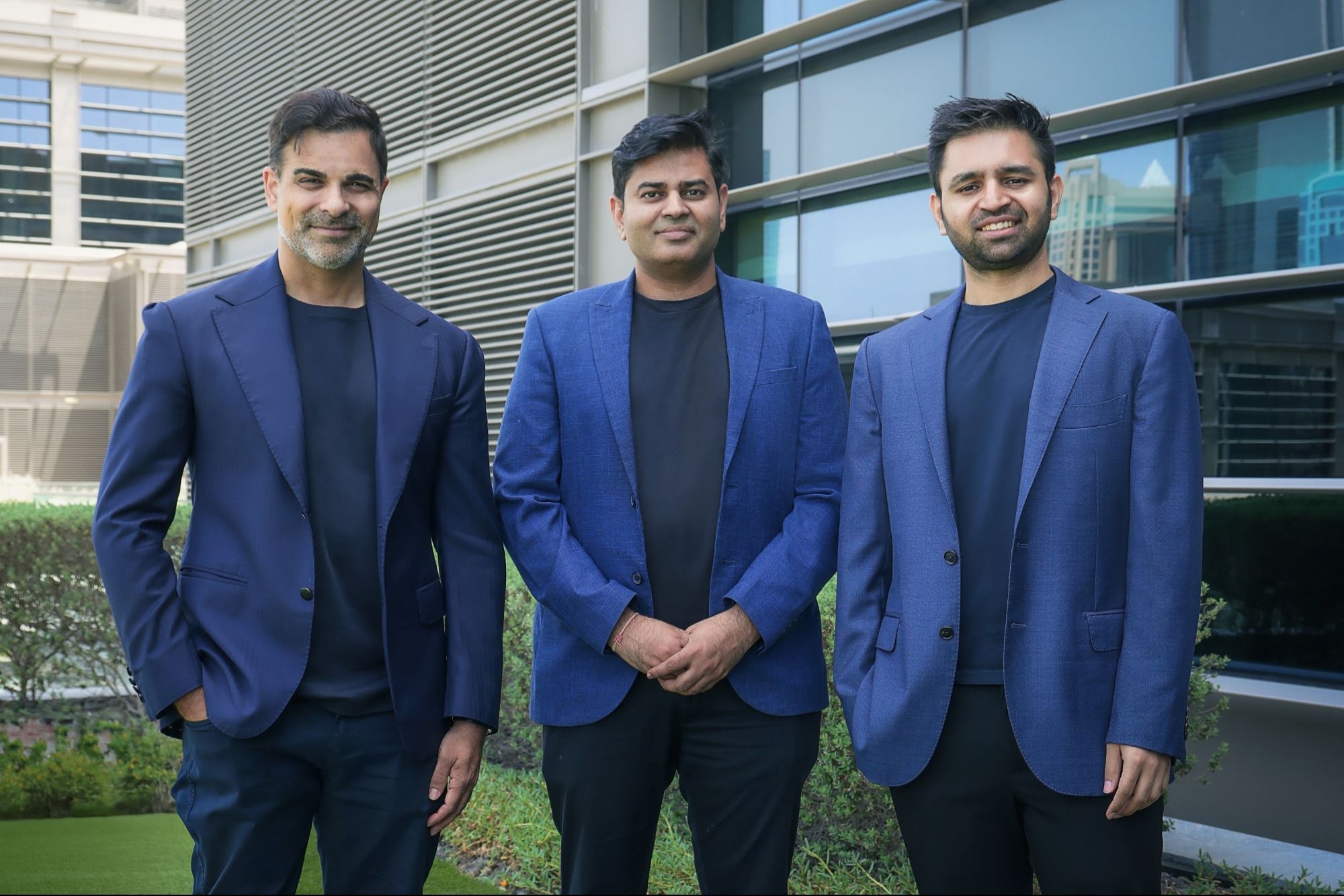 Mo Ali Yusuf with his two Fuze co-founders outside an office building