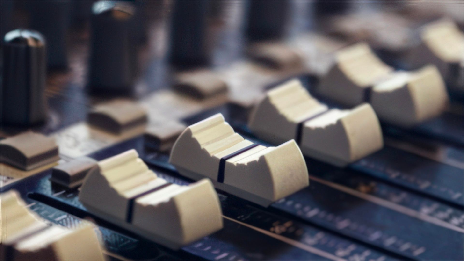 Faders on a Mocean sound-mixing console