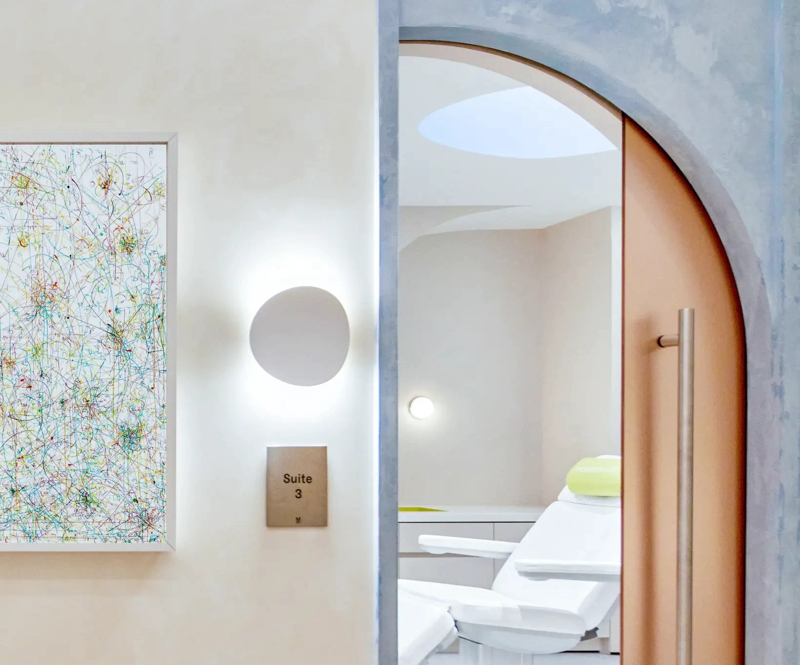 Modern Age studio interior with curved treatment-suite entrances