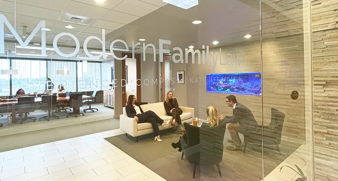 People talking in a seating area inside Modern Family Law’s Denver office