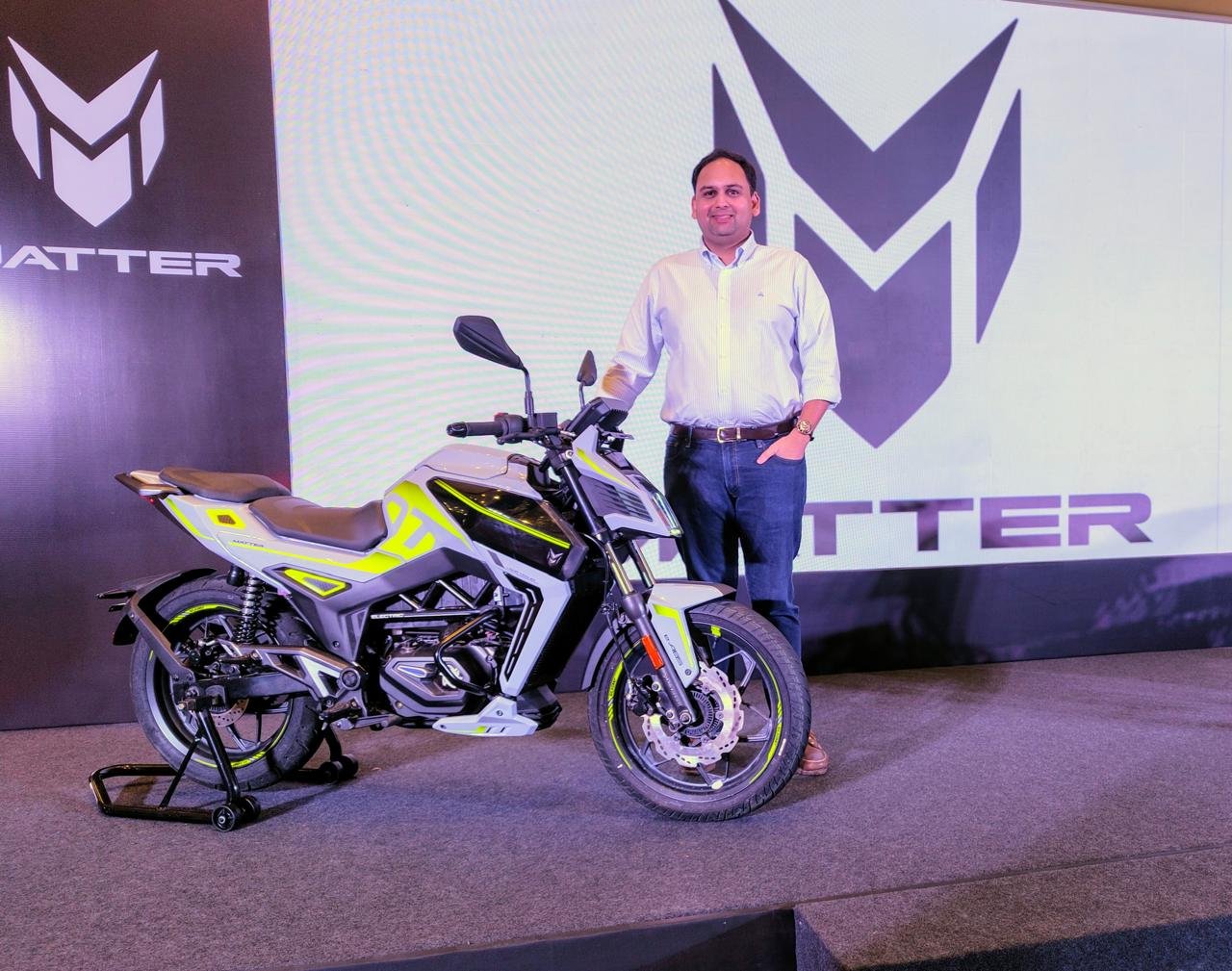 Mohal Lalbhai standing beside the Matter AERA 5000+ motorcycle