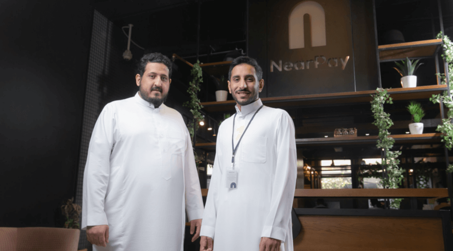 Nearpay co-founders Hamzah Al Ghamdi and Mohammad Aleban standing in the company’s office