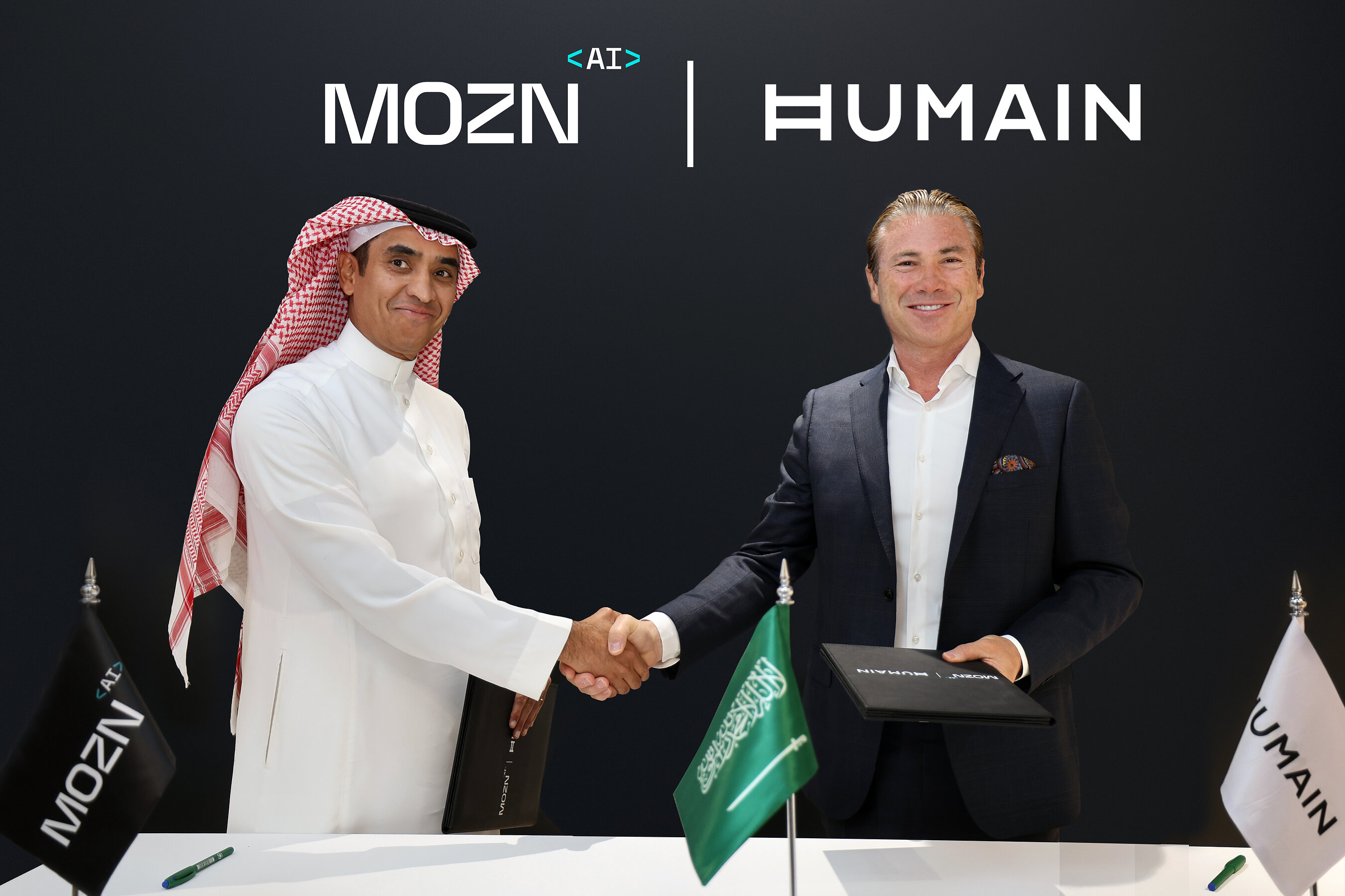 Mohammed Alhussein, left, shaking hands with HUMAIN CEO Tareq Amin at the partnership signing