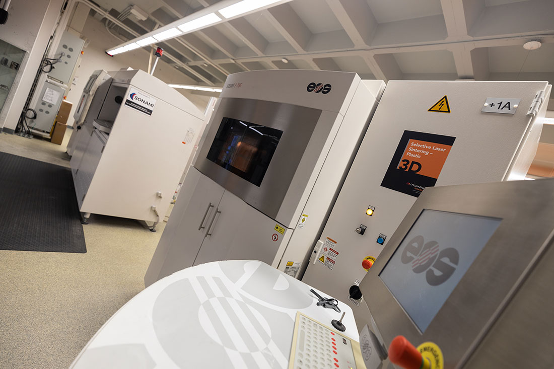 Mohawk IDEAWORKS researchers working with industrial equipment