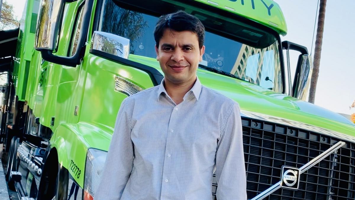 Mohit Aron standing beside a bright green Cohesity demonstration truck