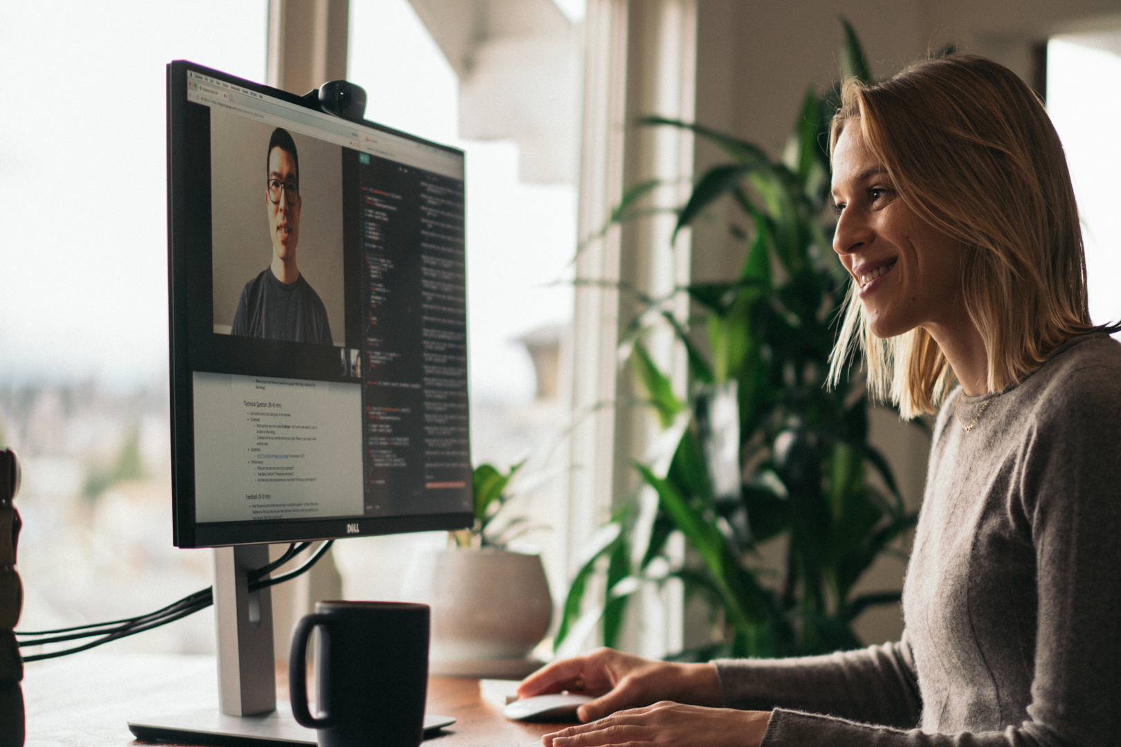 A Karat engineer conducting a technical interview by video on a computer