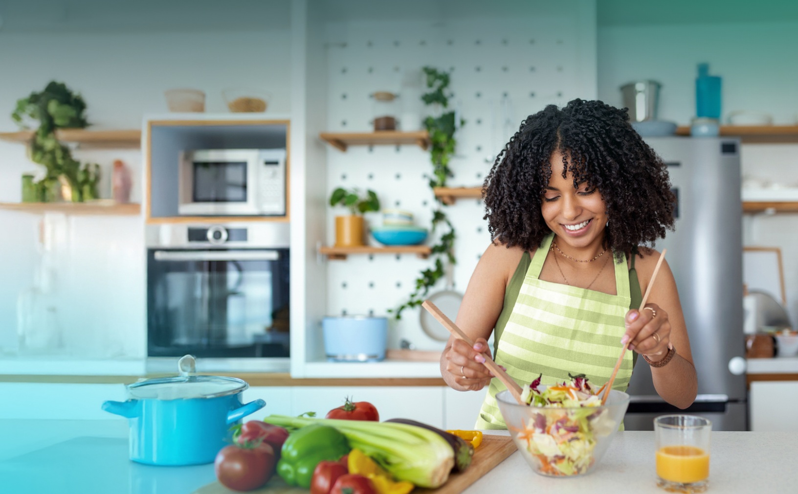 A woman preparing a salad in a kitchen, an illustrative photograph from Momentum’s Conagra case study