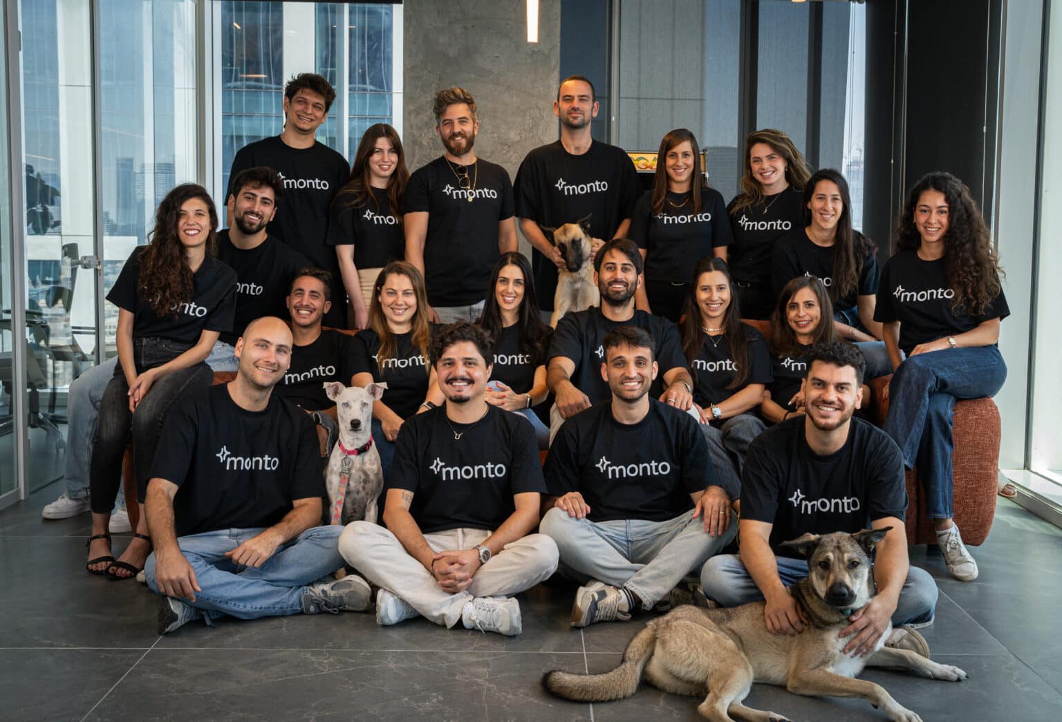 Monto’s early team in matching black shirts, joined by three dogs