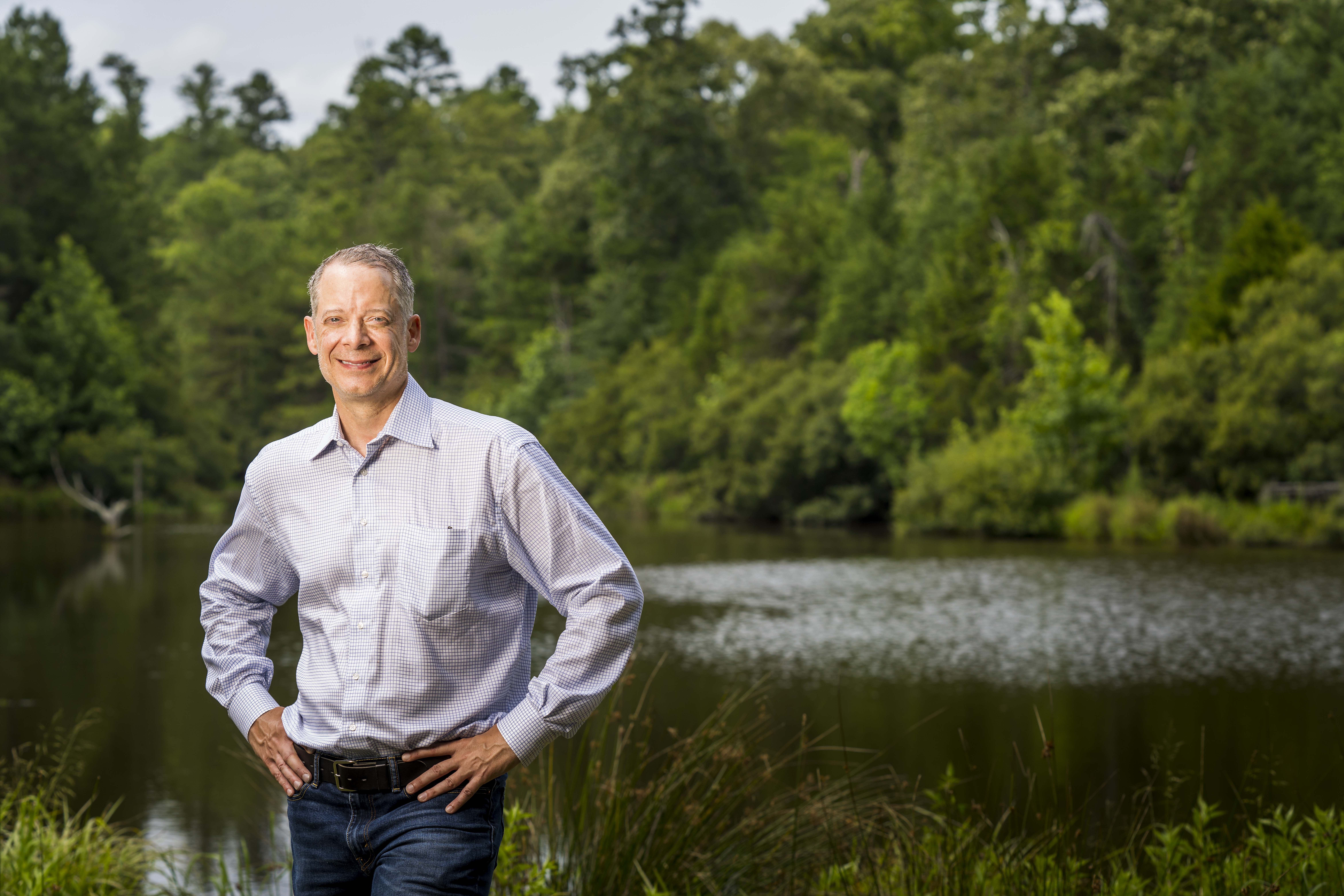 Monty Bennett beside a pond at his East Texas ranch