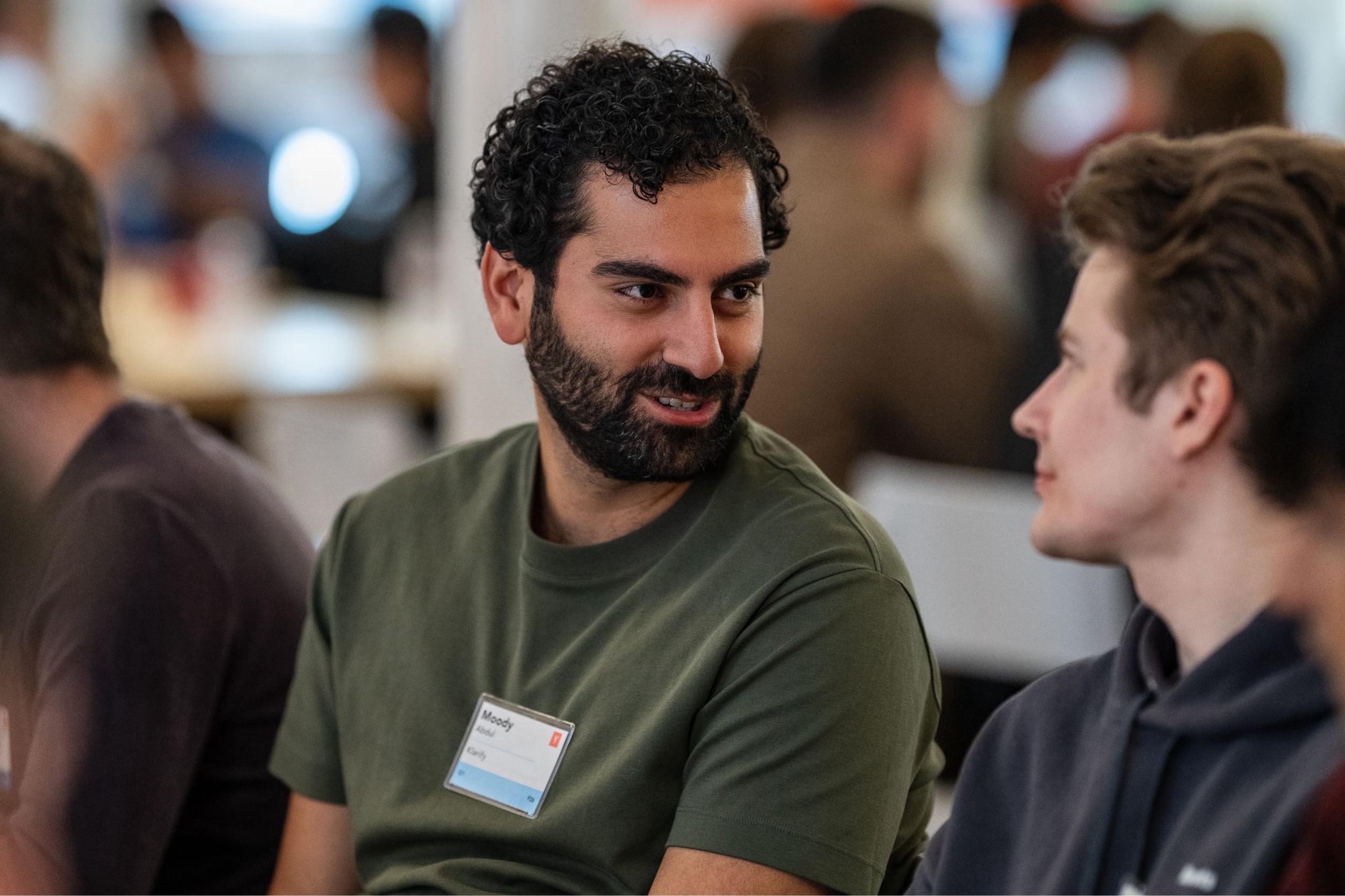 Moody Abdul in conversation with another attendee at a Y Combinator gathering