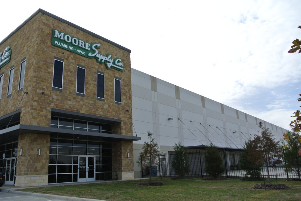 Moore Supply Dallas exterior, showing its stone entrance and adjoining warehouse