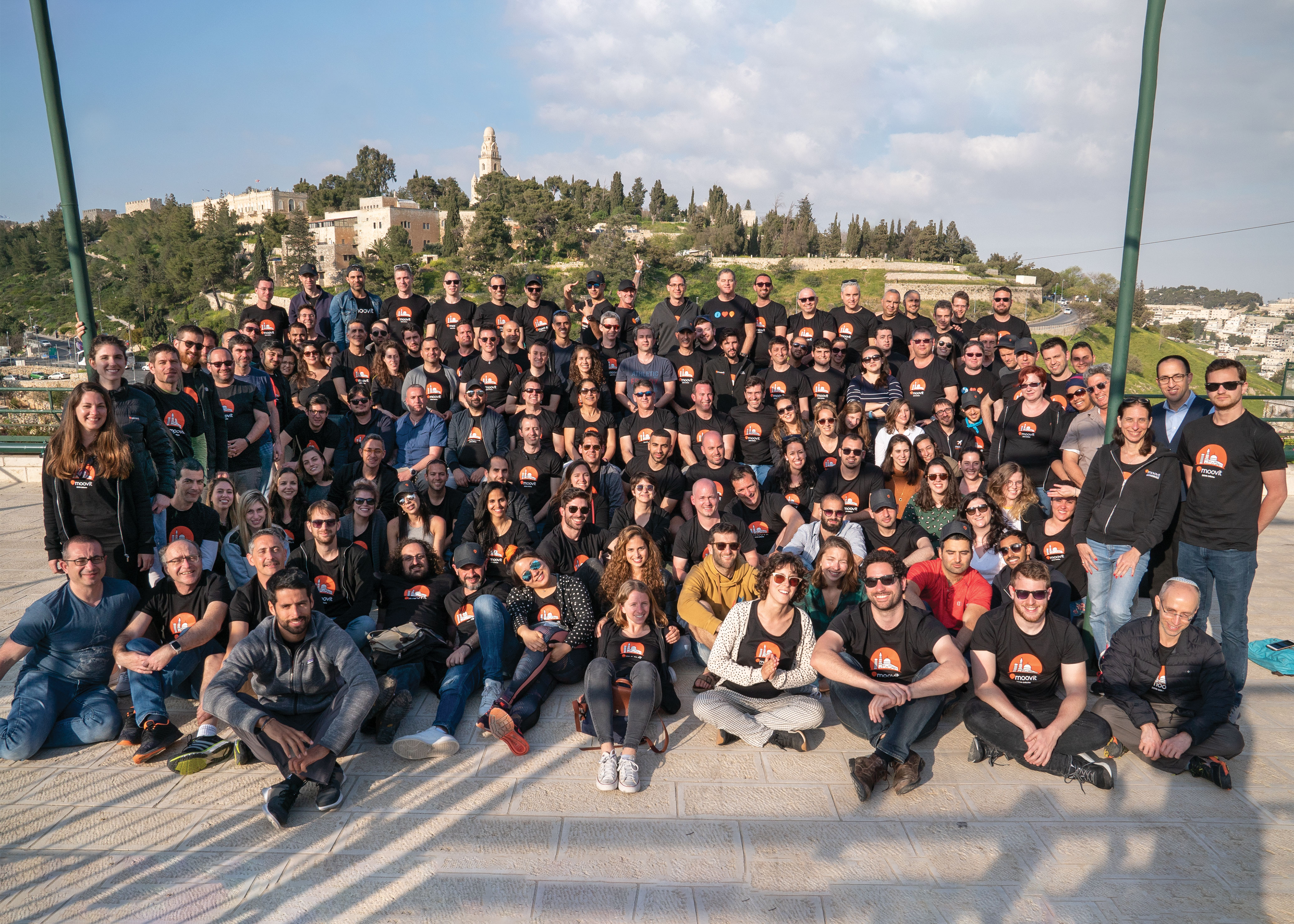 Moovit employees gathered outdoors for a company group photograph