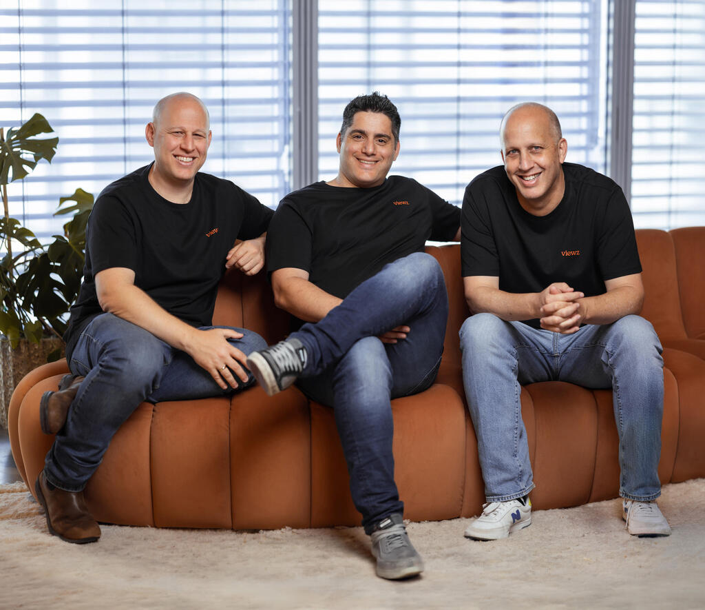 Moti Cohen, seated in the center, with his Viewz co-founders on an orange sofa