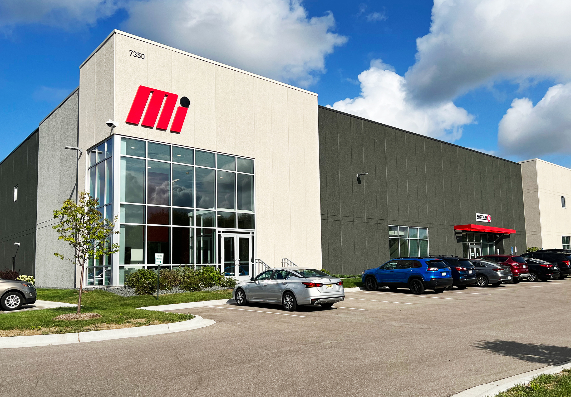 Motion AI’s Eden Prairie facility, with a glass entrance beneath the number 7350 and cars parked outside