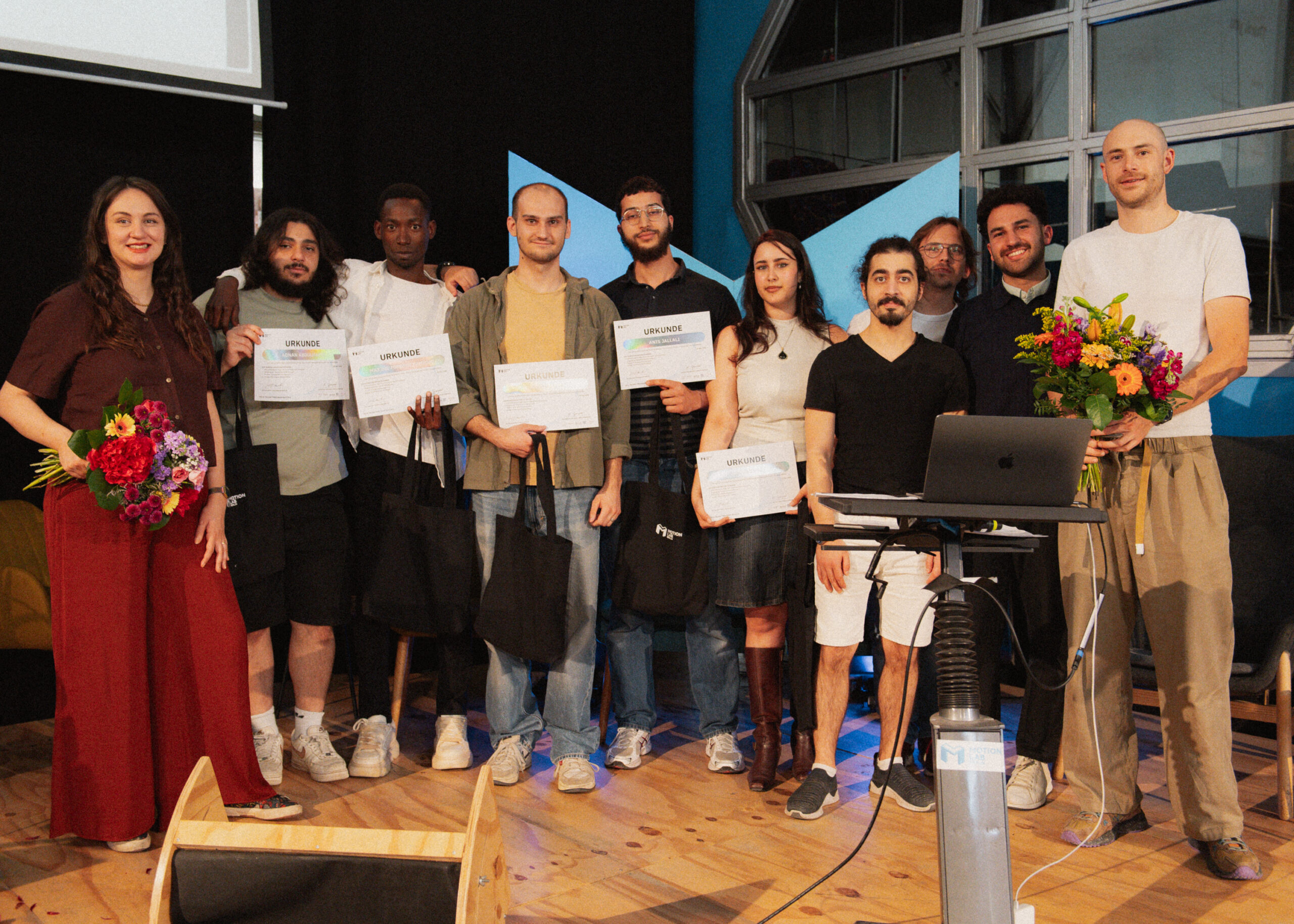 The alcemy challenge team posing with certificates and their equipment at Tech Talent Graduation Day