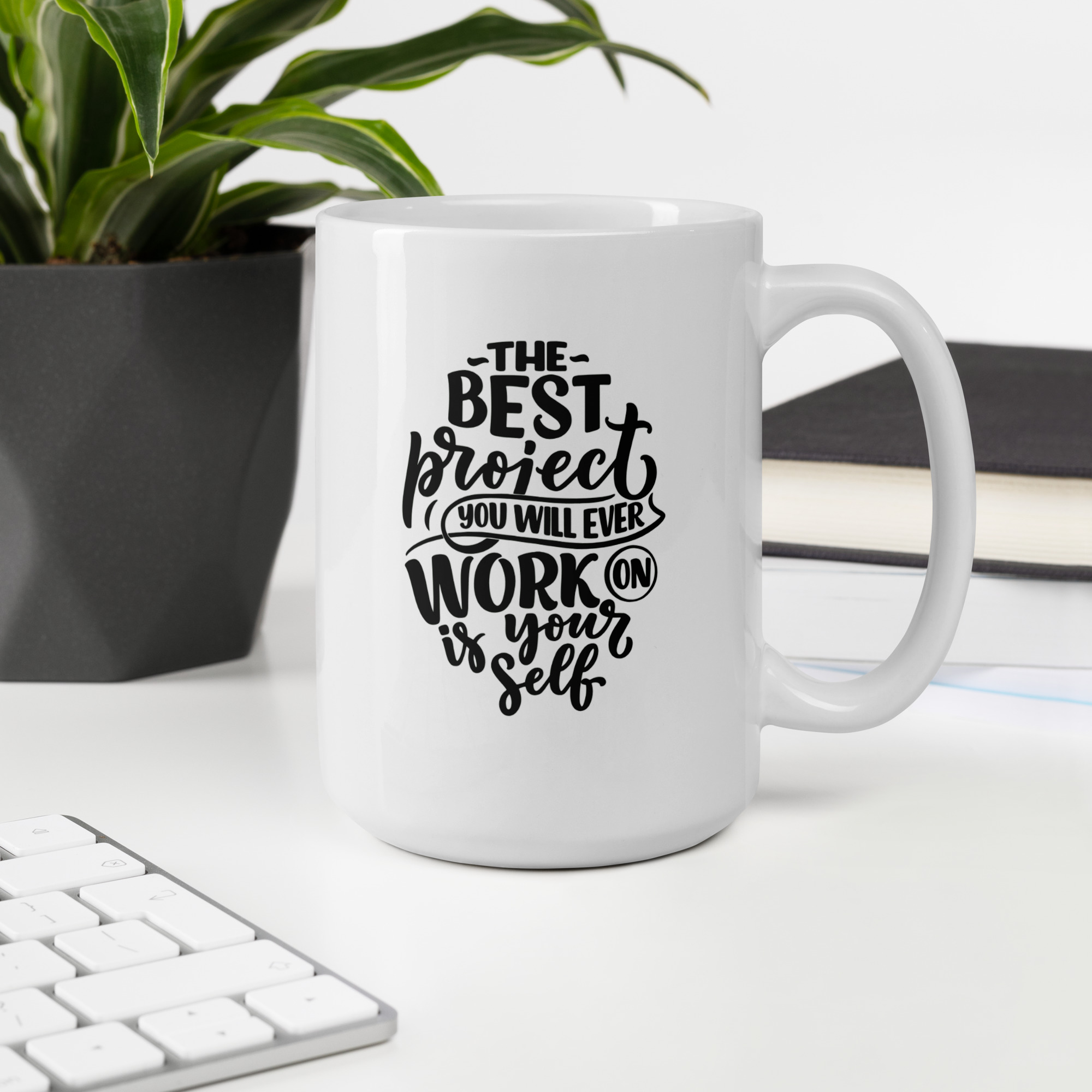 Motivational Lines ceramic mug displaying a message about working on yourself, beside a keyboard and plant
