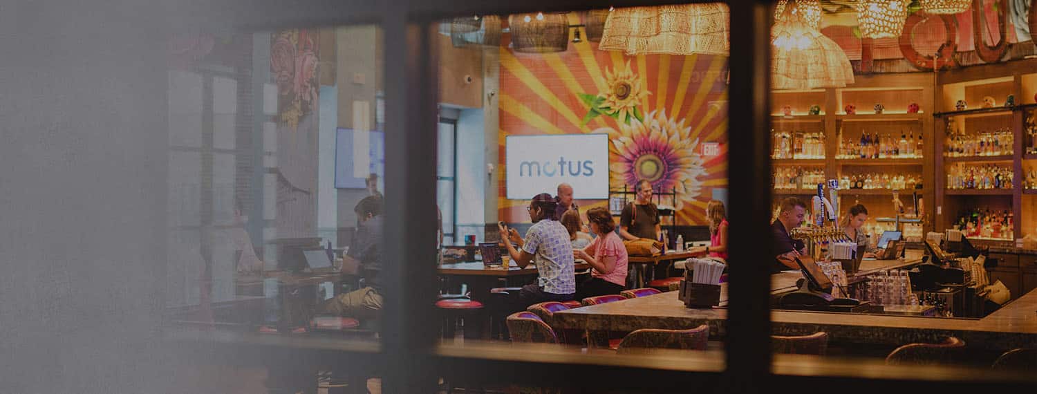 People gathered at a bar in a photograph published on Motus’s culture page