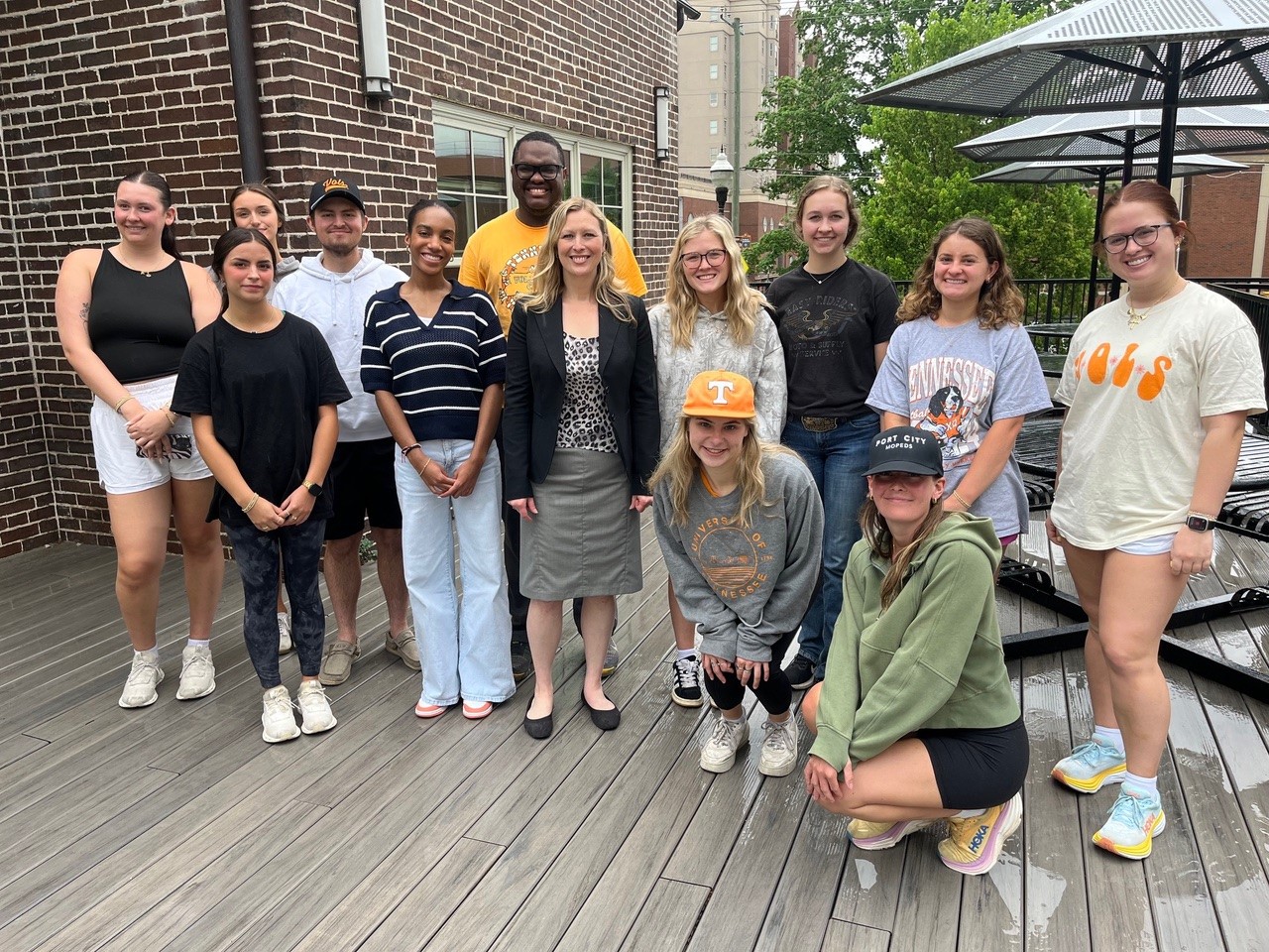 MoxCar staff member Catherine Howell with University of Tennessee public-relations students outdoors