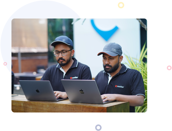 Two Mozilor team members working side by side on laptops