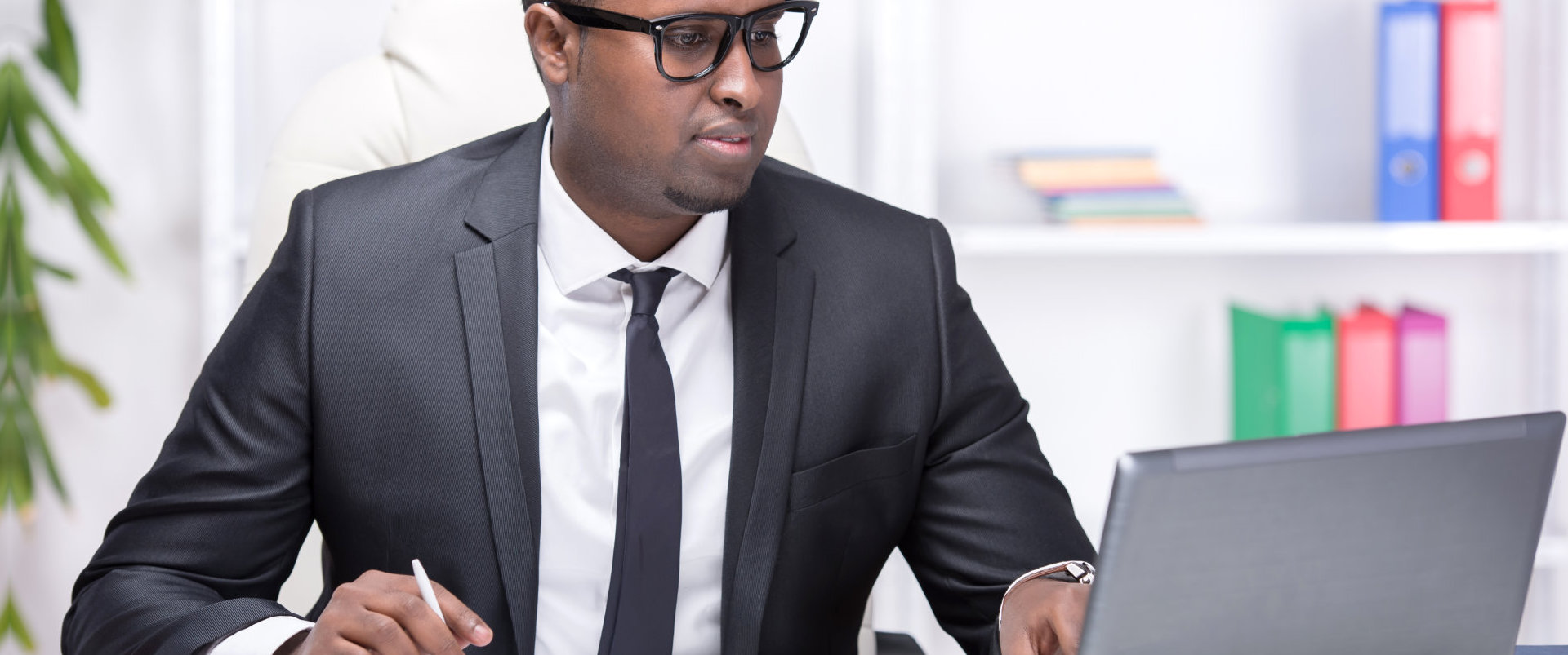 Illustrative stock photograph of a businessperson working at a laptop