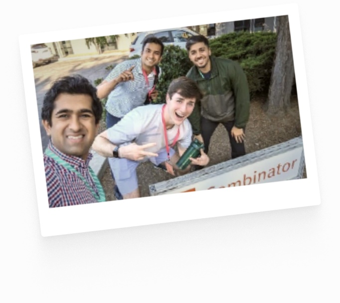 Mrinal Singh and fellow attendees beside a Y Combinator sign