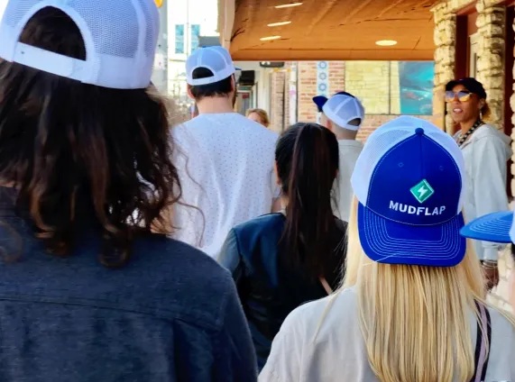 Mudflap teammates wearing branded caps on an outing