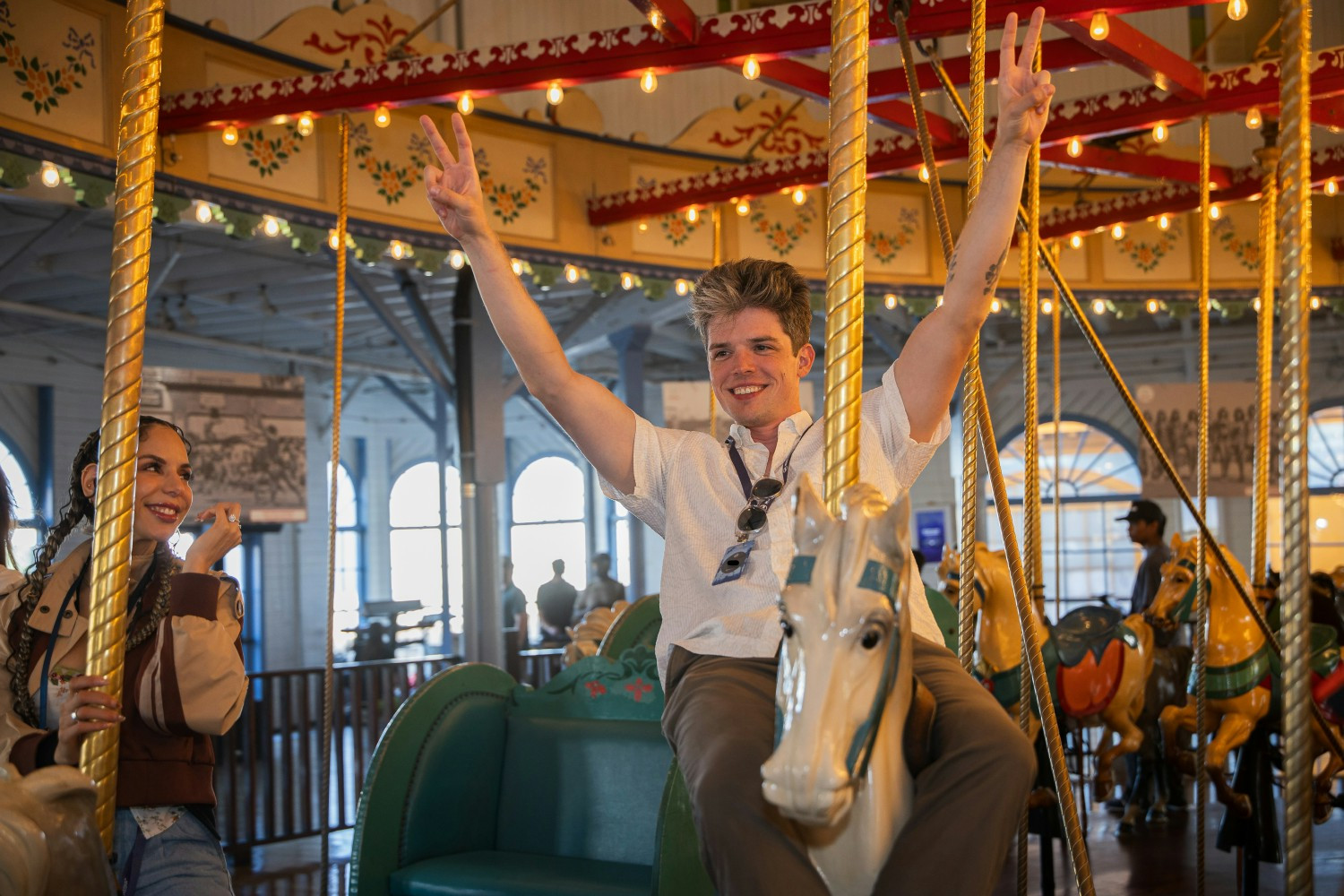 Multi Media team members enjoying a carousel at a company celebration