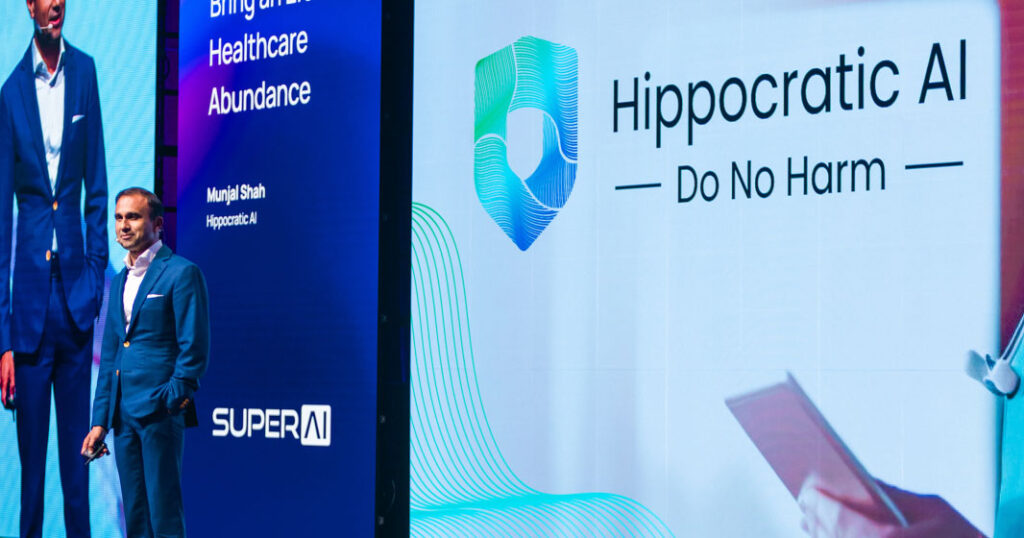 Munjal Shah speaking on stage at a SuperAI event, with Hippocratic AI's name on the screen