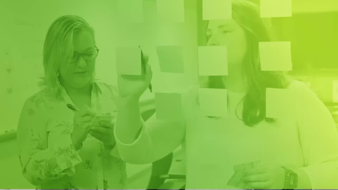 MurphyEpson team members working with notes on a glass wall
