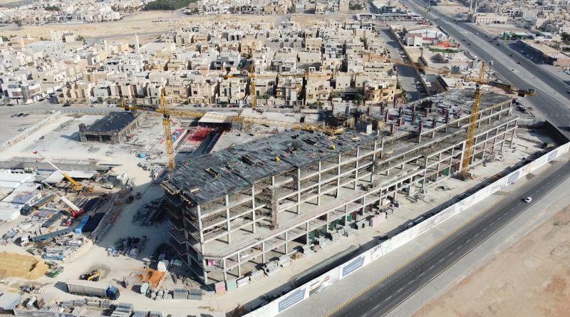 Elevated view of the Al-Arid construction site, showing the concrete structure, cranes and surrounding streets