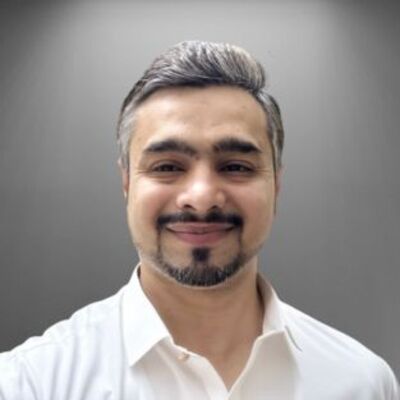 Muhammad Muzammil Rawjani smiling in a white shirt