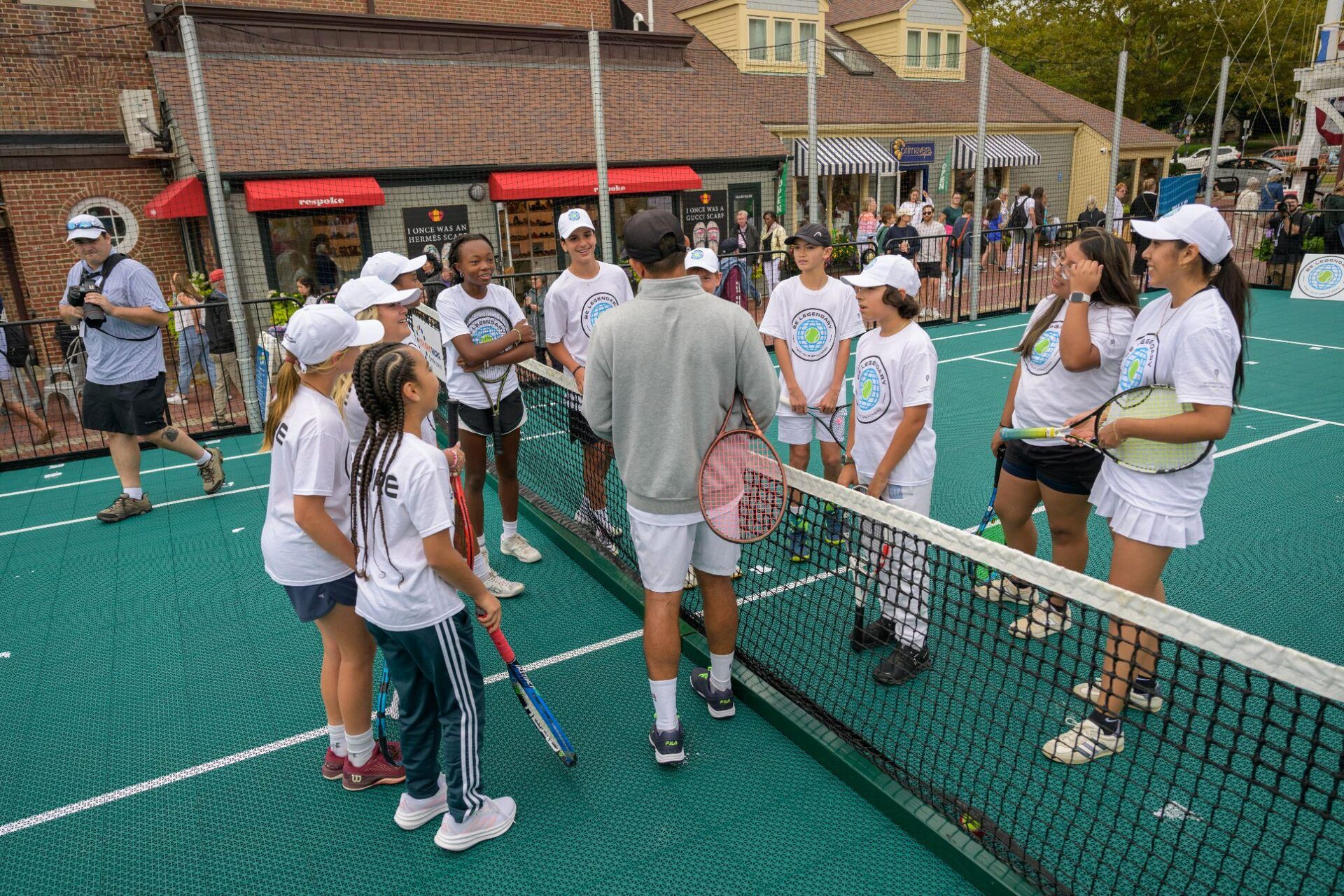 Young tennis players at the net during the Be Legendary program