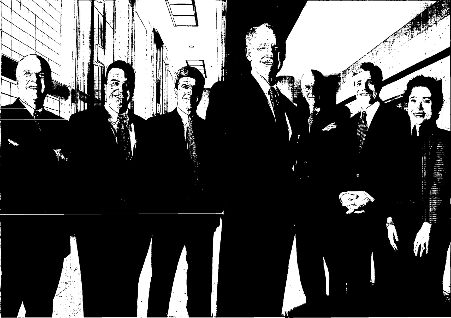 Labcorp’s seven executive officers in 2004, standing in a corridor; Myla Lai-Goldman is at the far right.