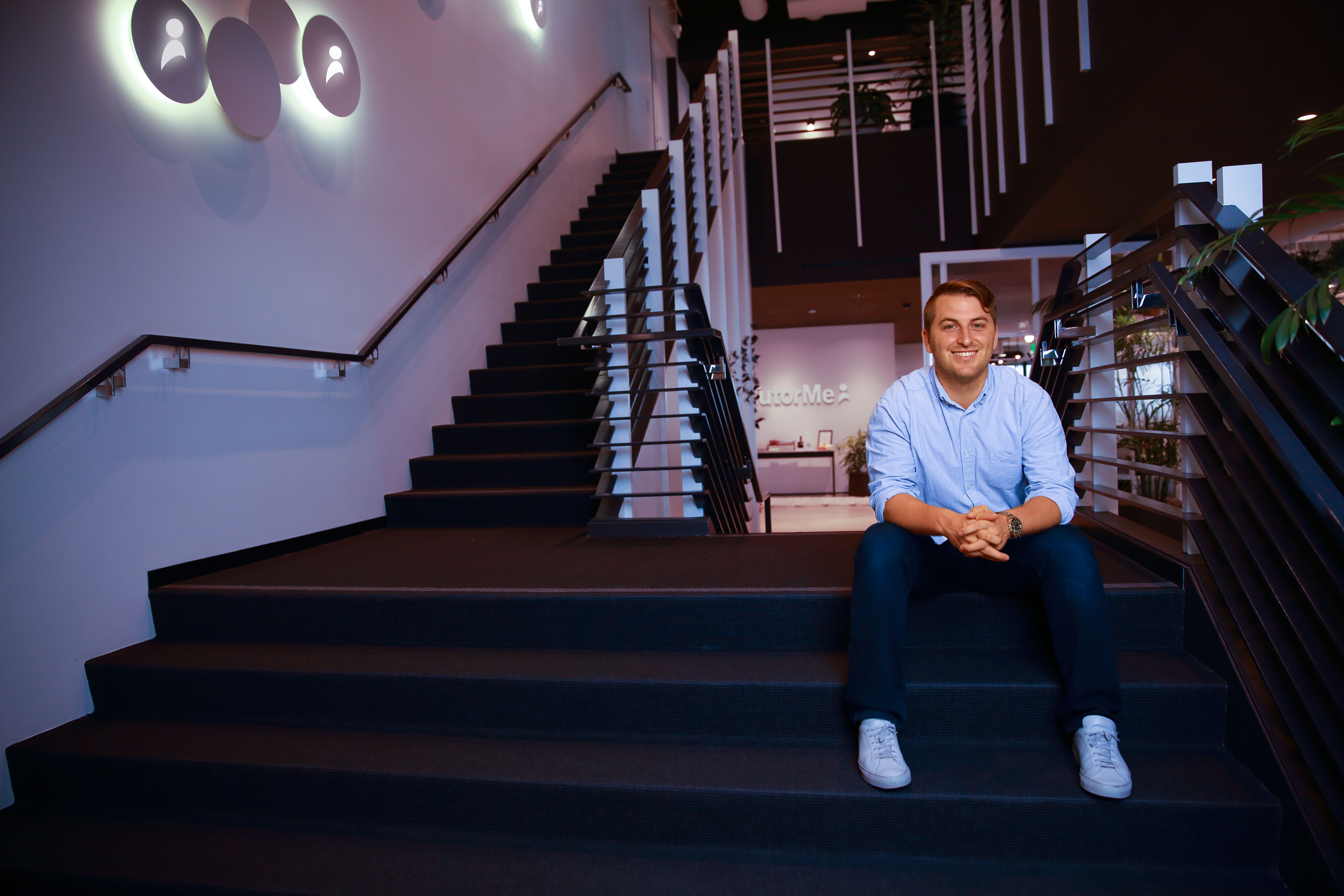 Myles Hunter seated on stairs in a TutorMe office
