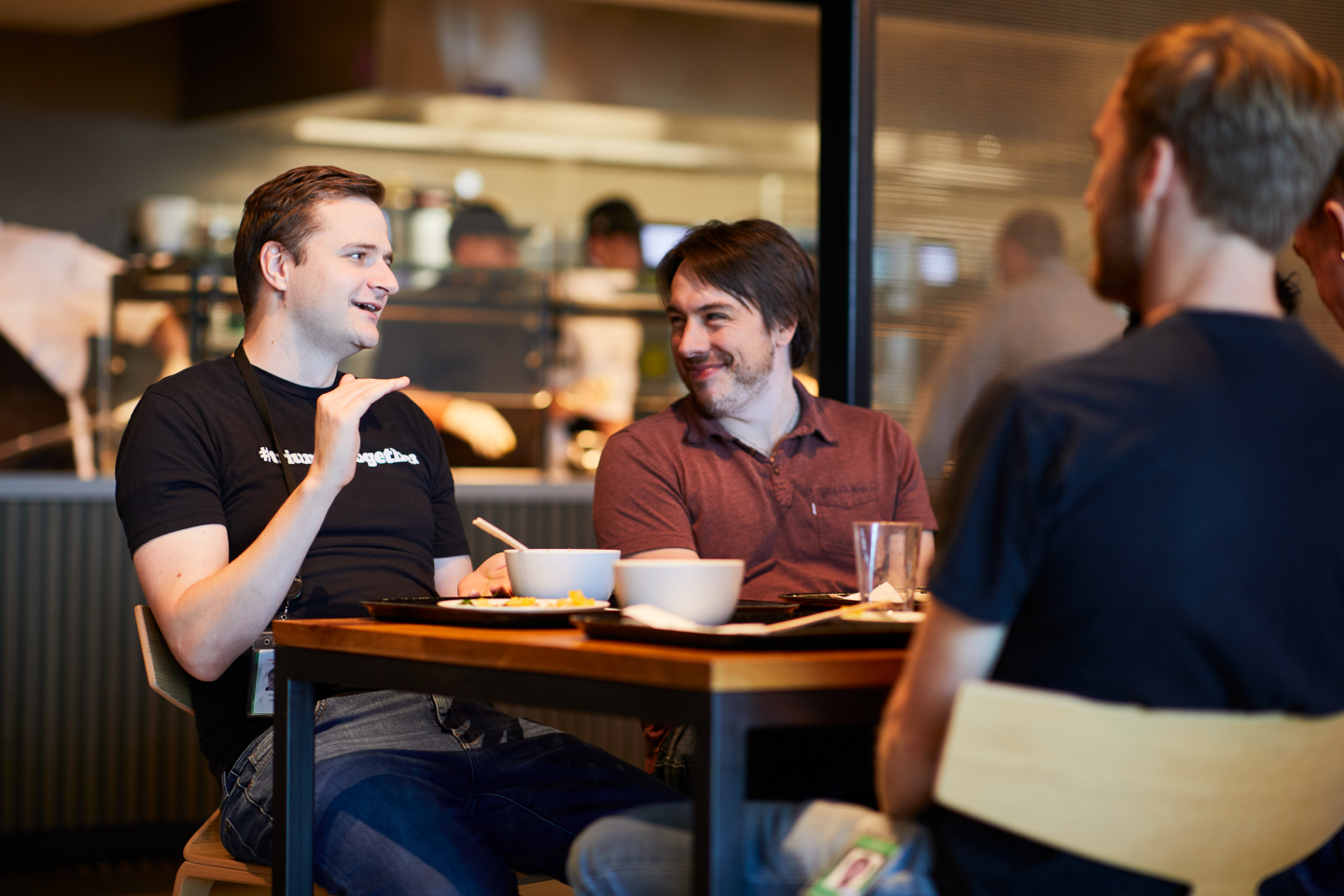 Machine Zone team members in conversation at the office