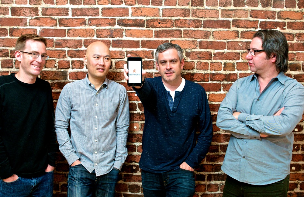 Original N3TWORK founders Steve Detwiler, Alan Yu, Neil Young and Bob Stevenson standing against a brick wall