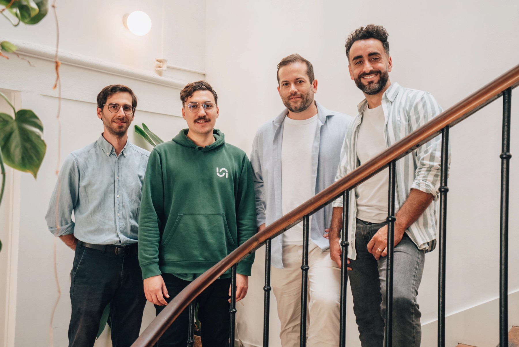 Naboo’s four cofounders standing together on an office staircase