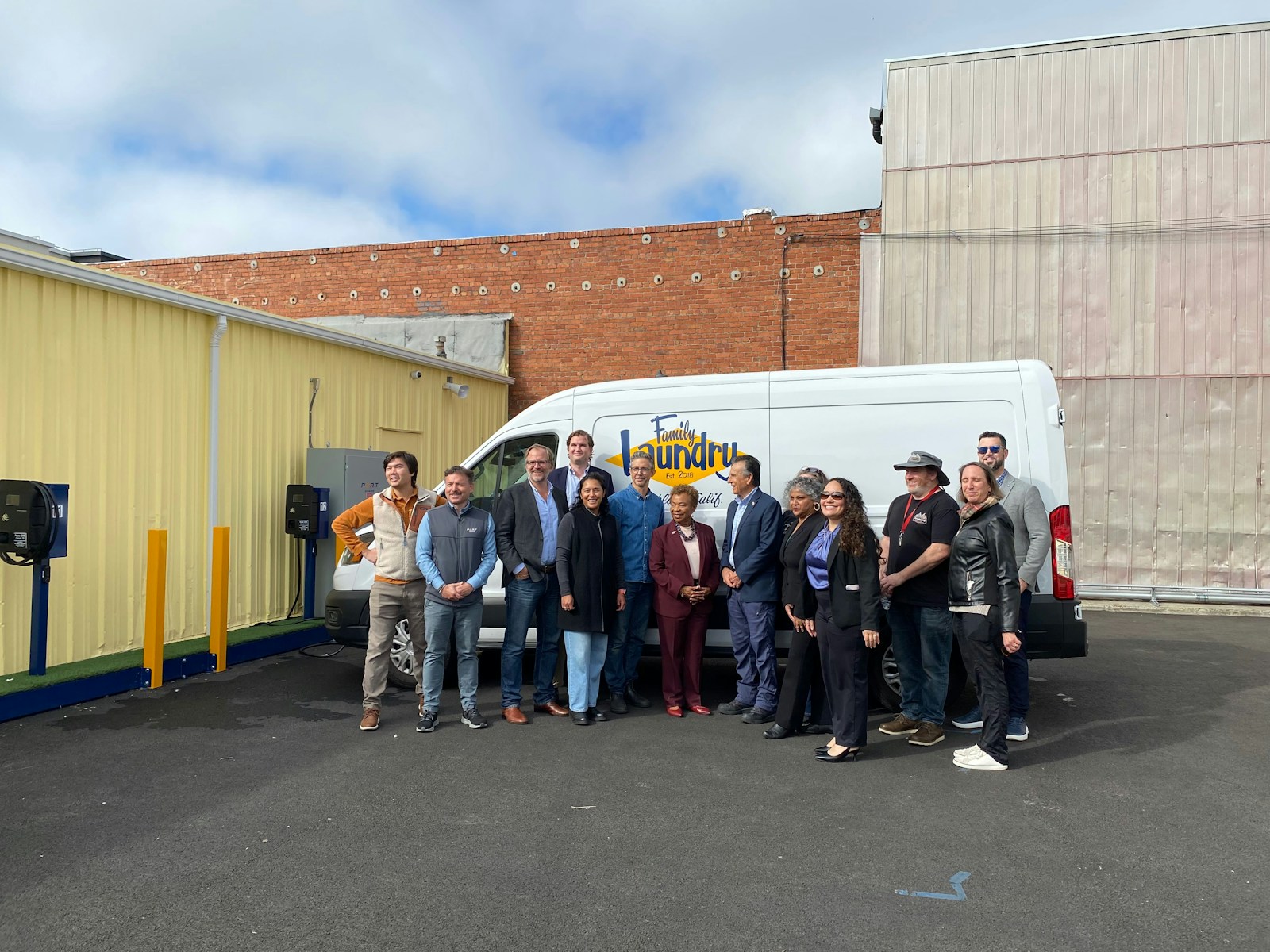 Nadav Gur, second from left, with Oakland Mayor Barbara Lee, Family Laundry staff and project partners at the opening of a solar-powered EV depot