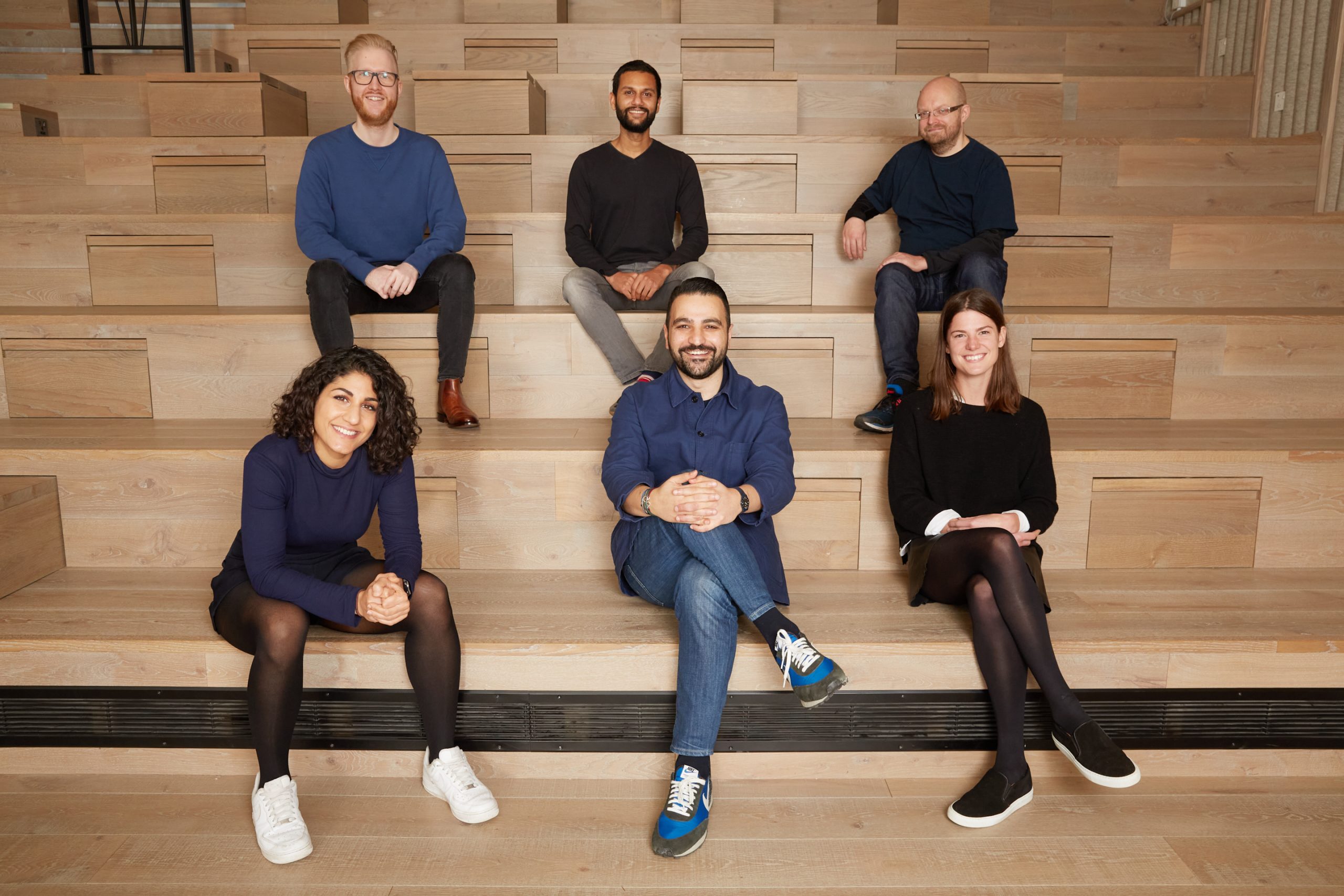 Nader AlSalim seated front centre with five members of Gaia’s early team on wooden steps