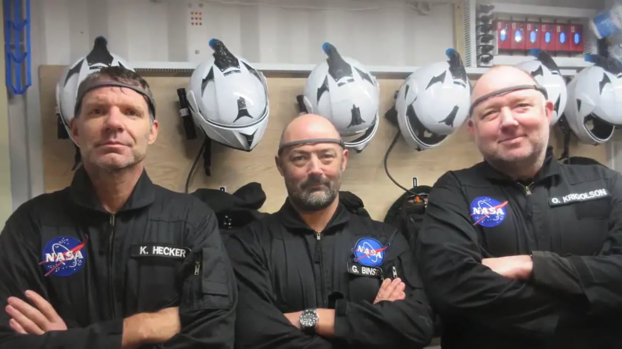 Three crew members wearing Muse headbands in a NASA field setting