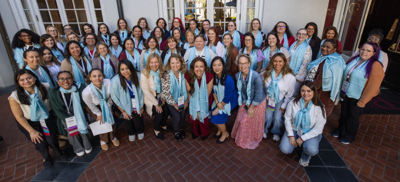 More than 40 attendees from the SafetyChain Summit women's leadership gathering pose together in a courtyard