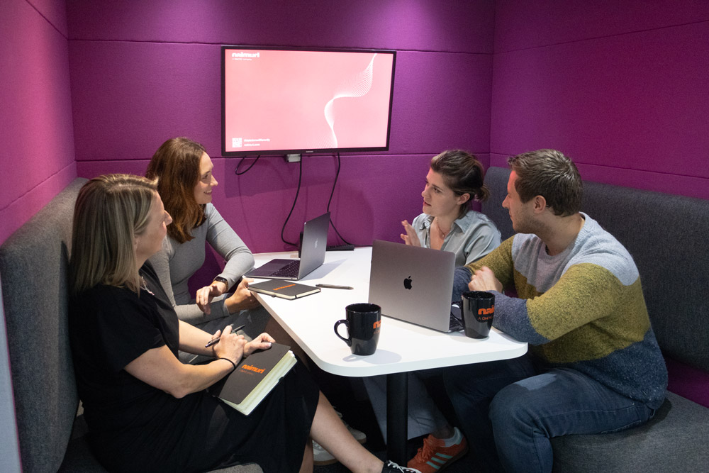 Four Naimuri colleagues in a working session around a table