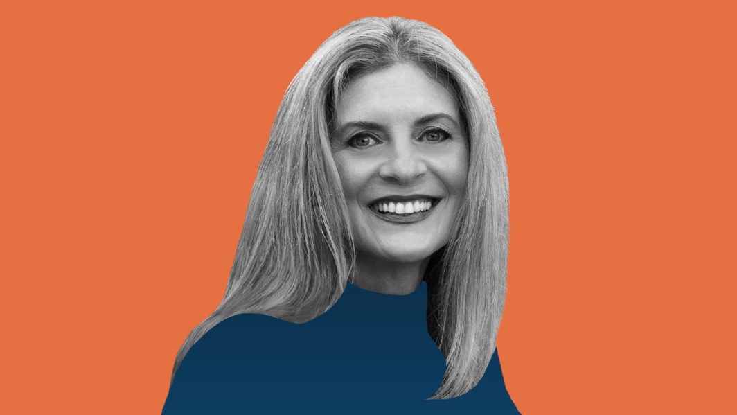 Nancy Stagliano in a black-and-white press portrait on an orange background