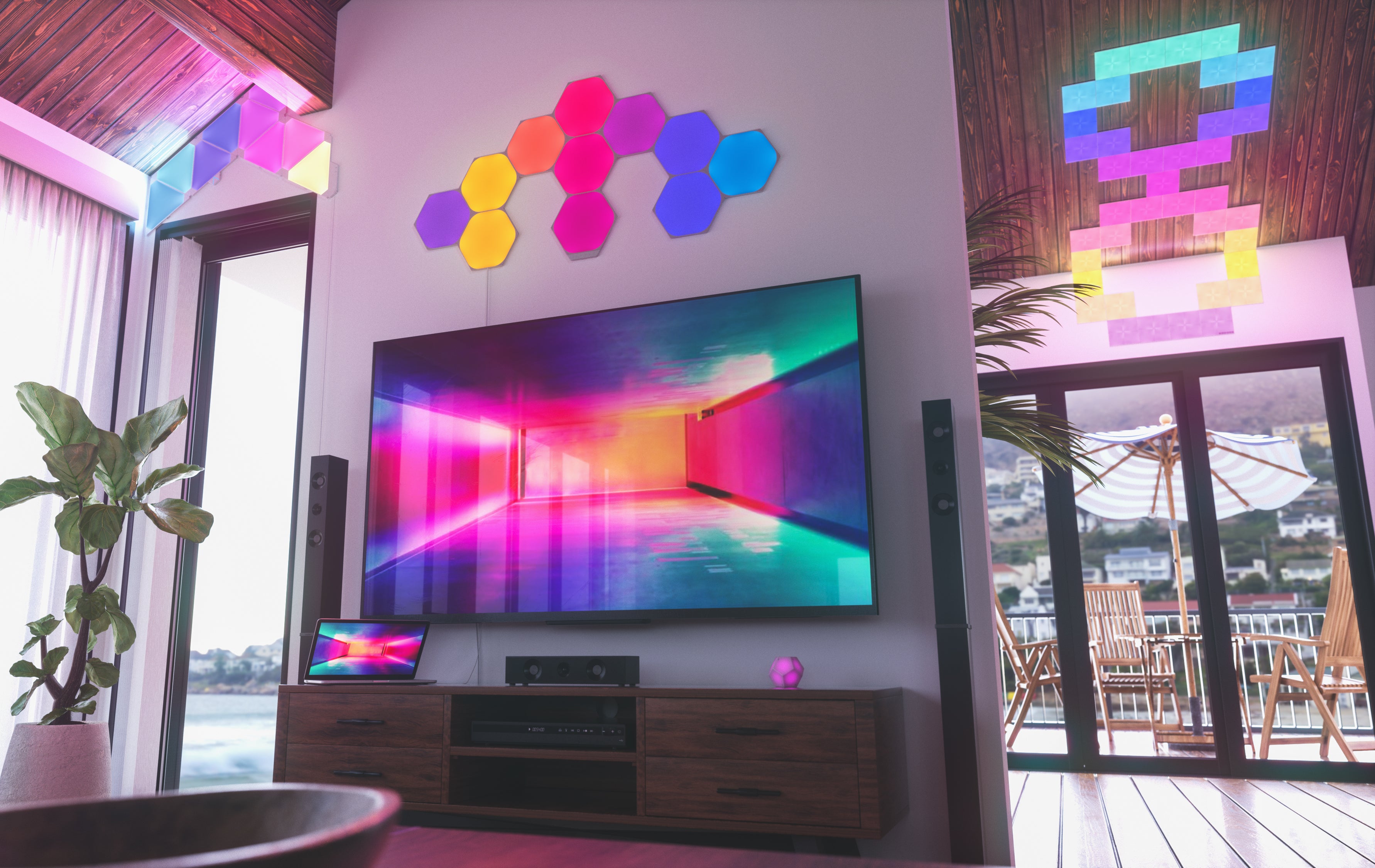 A living room illuminated by colorful Nanoleaf modular panels around a television