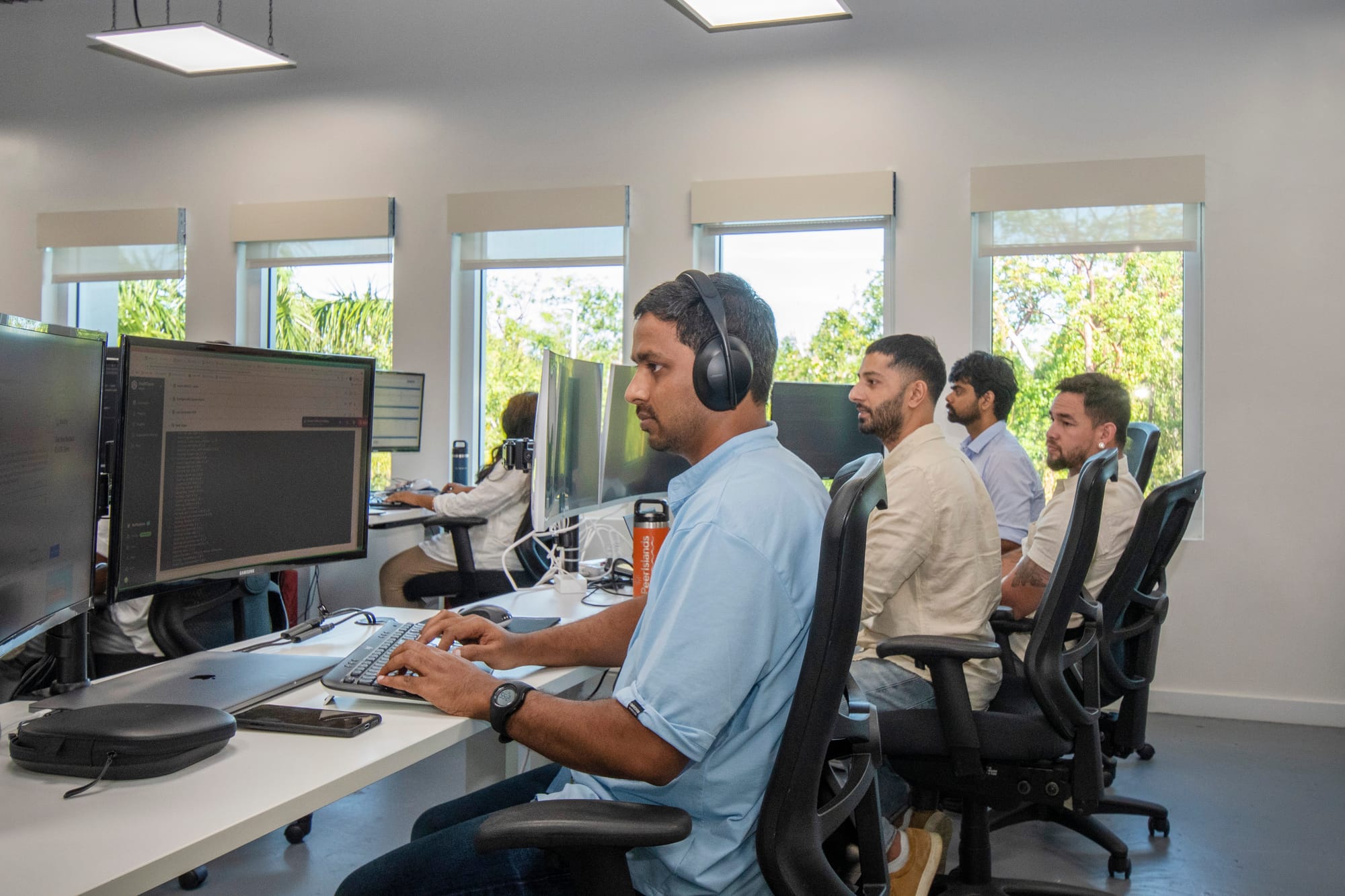 PeerIslands engineers working at monitors in a bright office