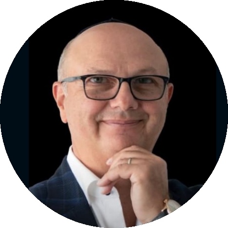 AxiomSL co-founder Alexander Tsigutkin, wearing glasses and a suit
