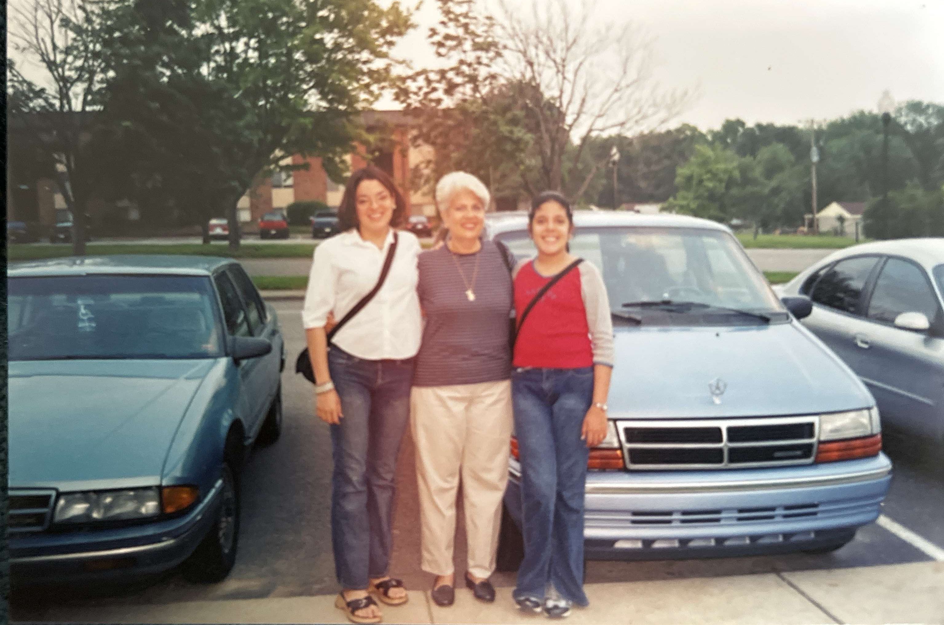An archival photograph from Natalia Bishop’s collection showing three women beside parked cars
