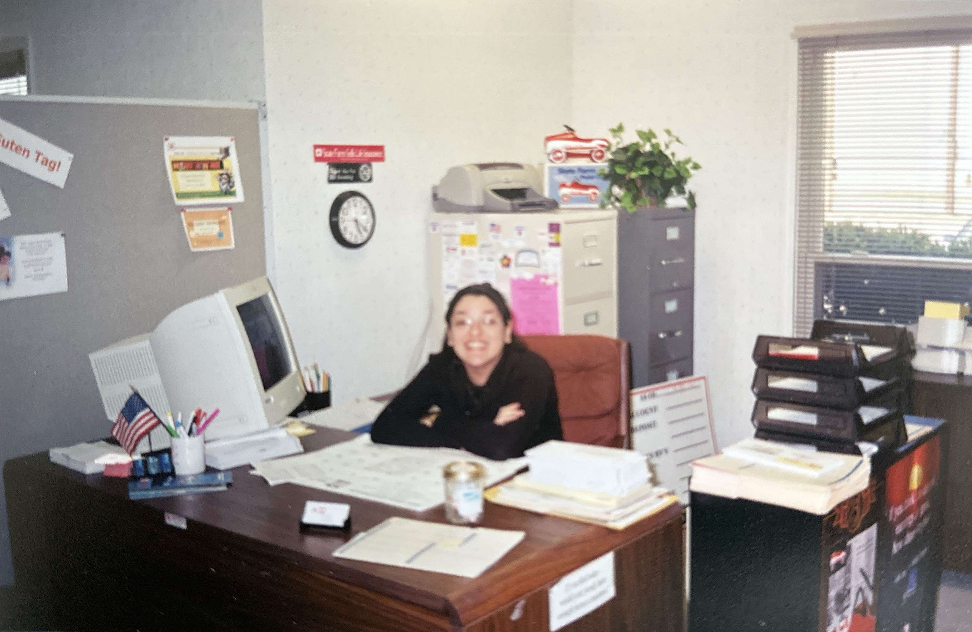 An archival photograph of Natalia Bishop seated behind a desk in an office