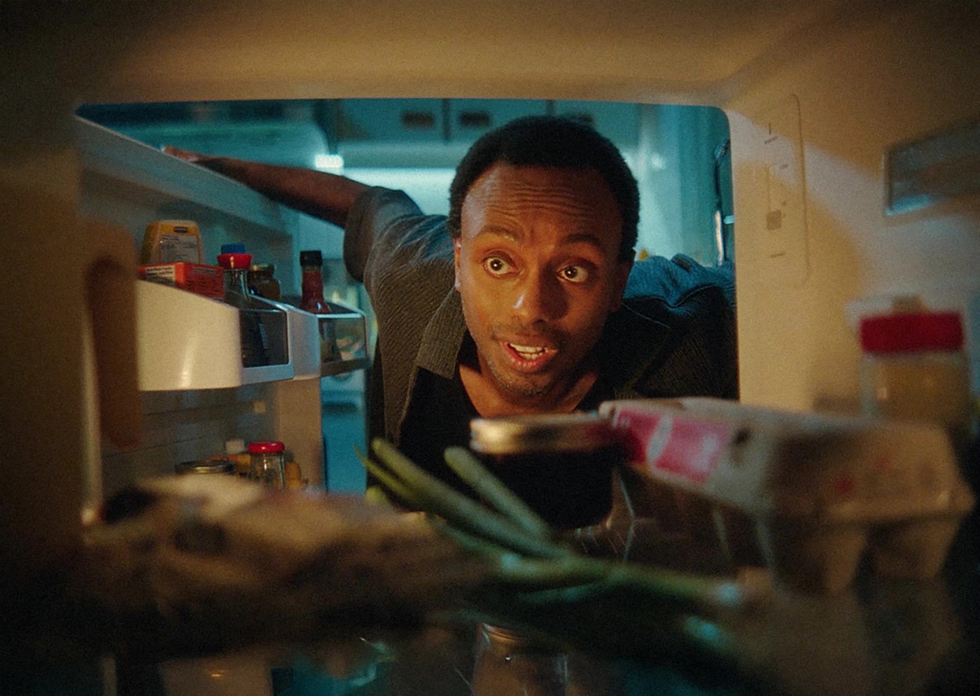 A person looks into a refrigerator in a frame from the You have eggs campaign