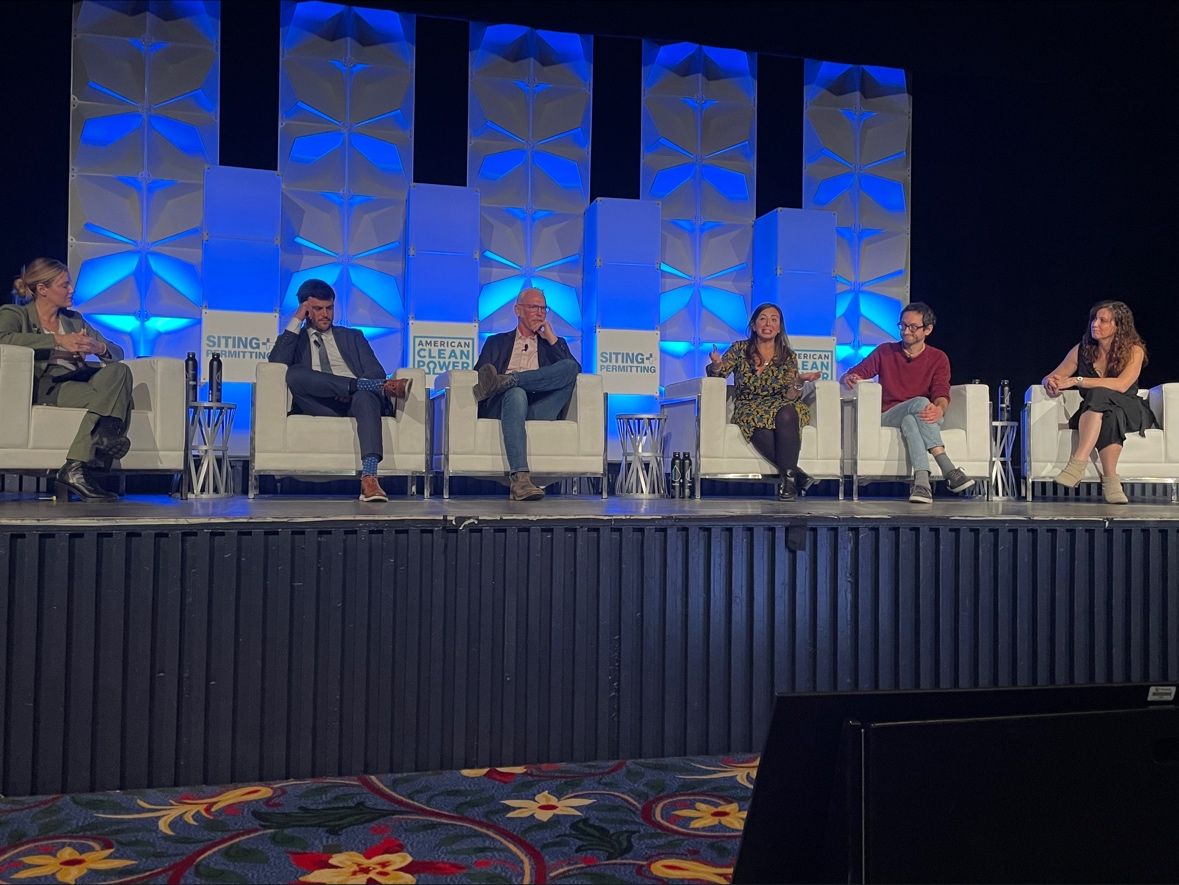 Six participants seated onstage at the American Clean Power Siting and Permitting conference